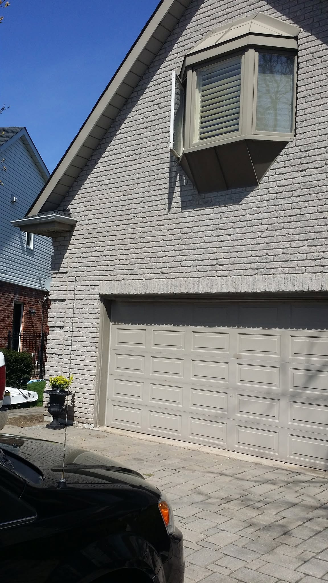 Before view of original grey brick exterior before stone transformation