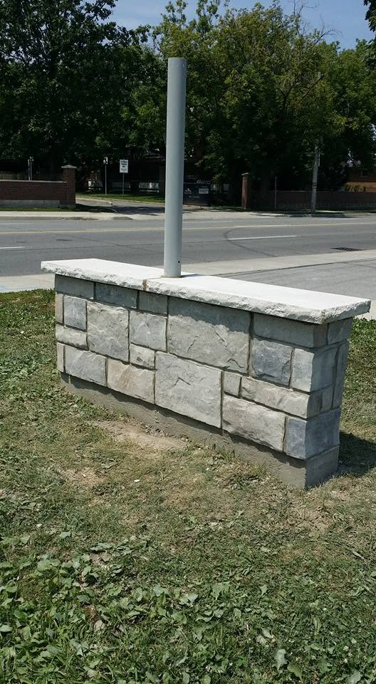 Commercial stone sign pillar with natural stone veneer and capstone
